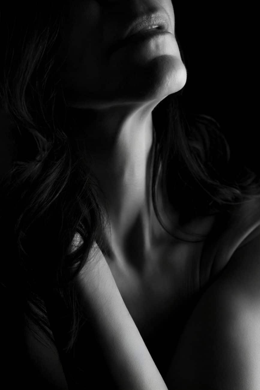 Sensual, faceless boudoir portrait with artistic shadows and elegant posing — a celebration of self-love.