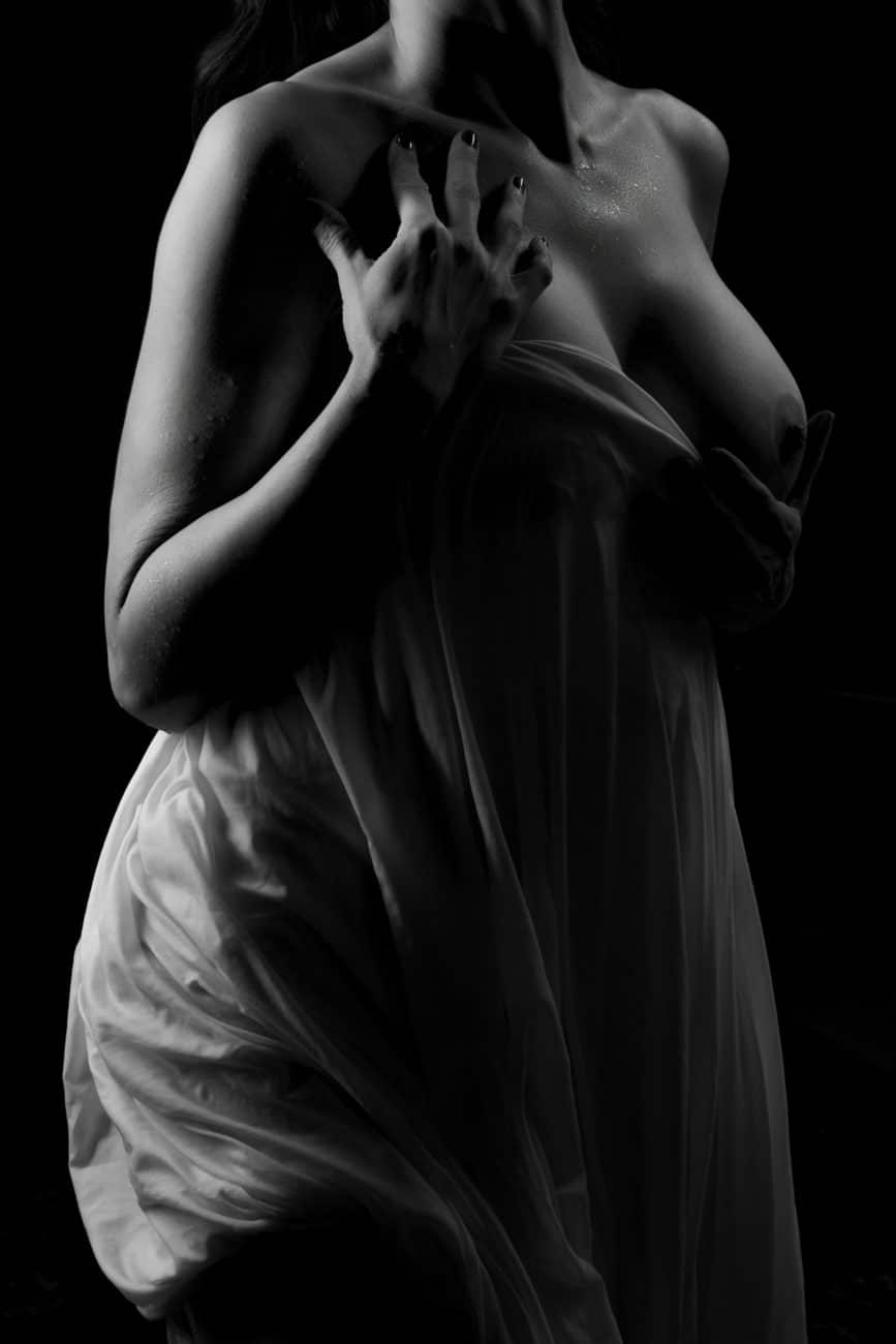 Black and white bodyscaping of woman draped in wet sheet