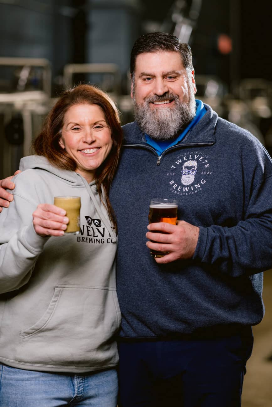 Steve and Kara Rogacki cozy up in front of their incredible brewing equipment, welcoming you to join them for a pint and sign up for some of their local events. 