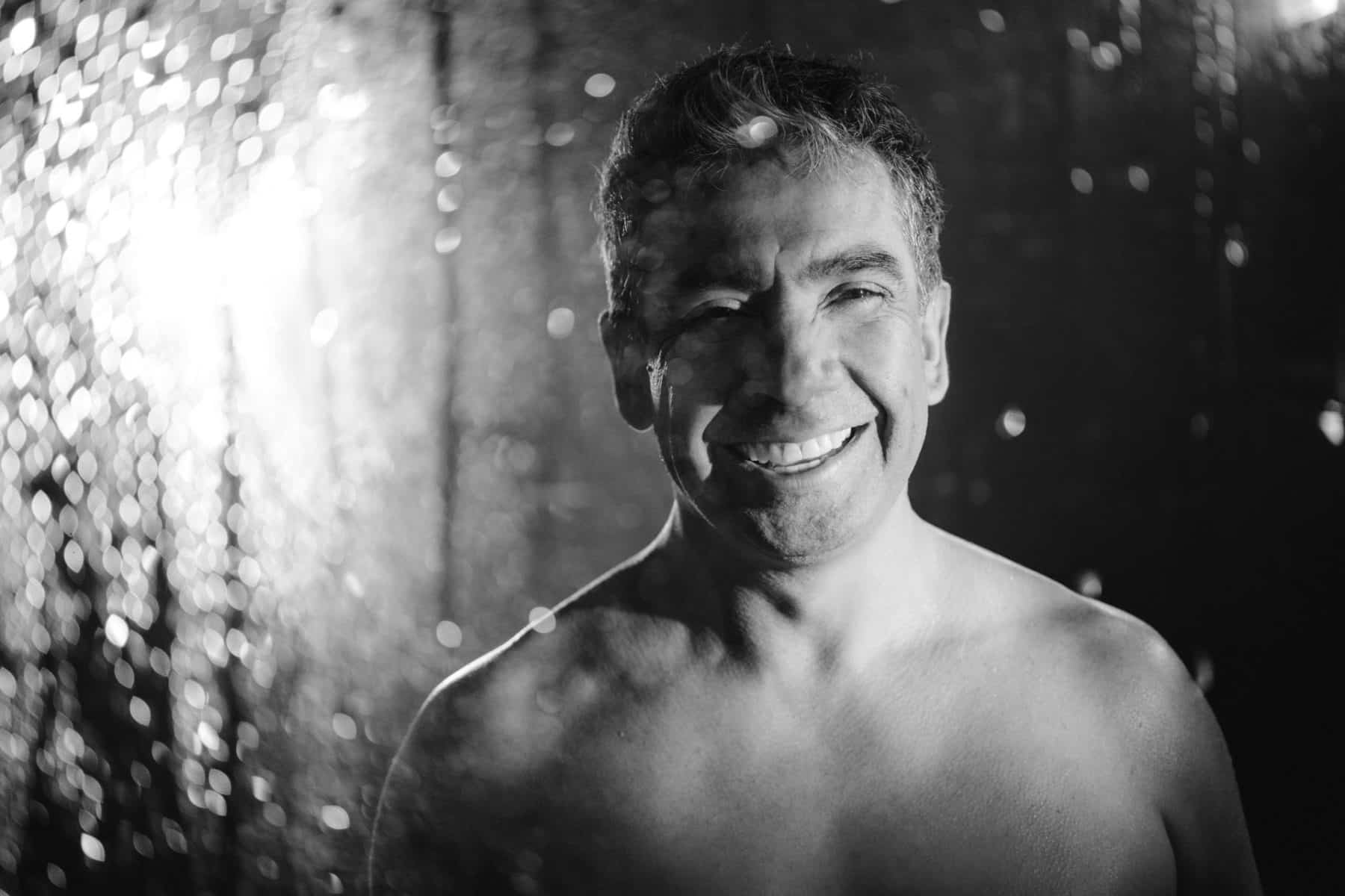 Men’s boudoir photography session featuring a bold and empowering shower scene.