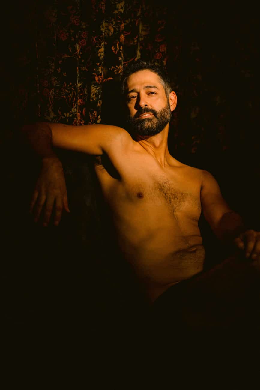 Men's Boudoir, shirtless, bearded man looking into camera