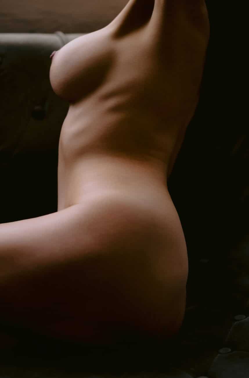 Editorial-style boudoir photograph featuring soft skin, feminine form, and empowered energy.