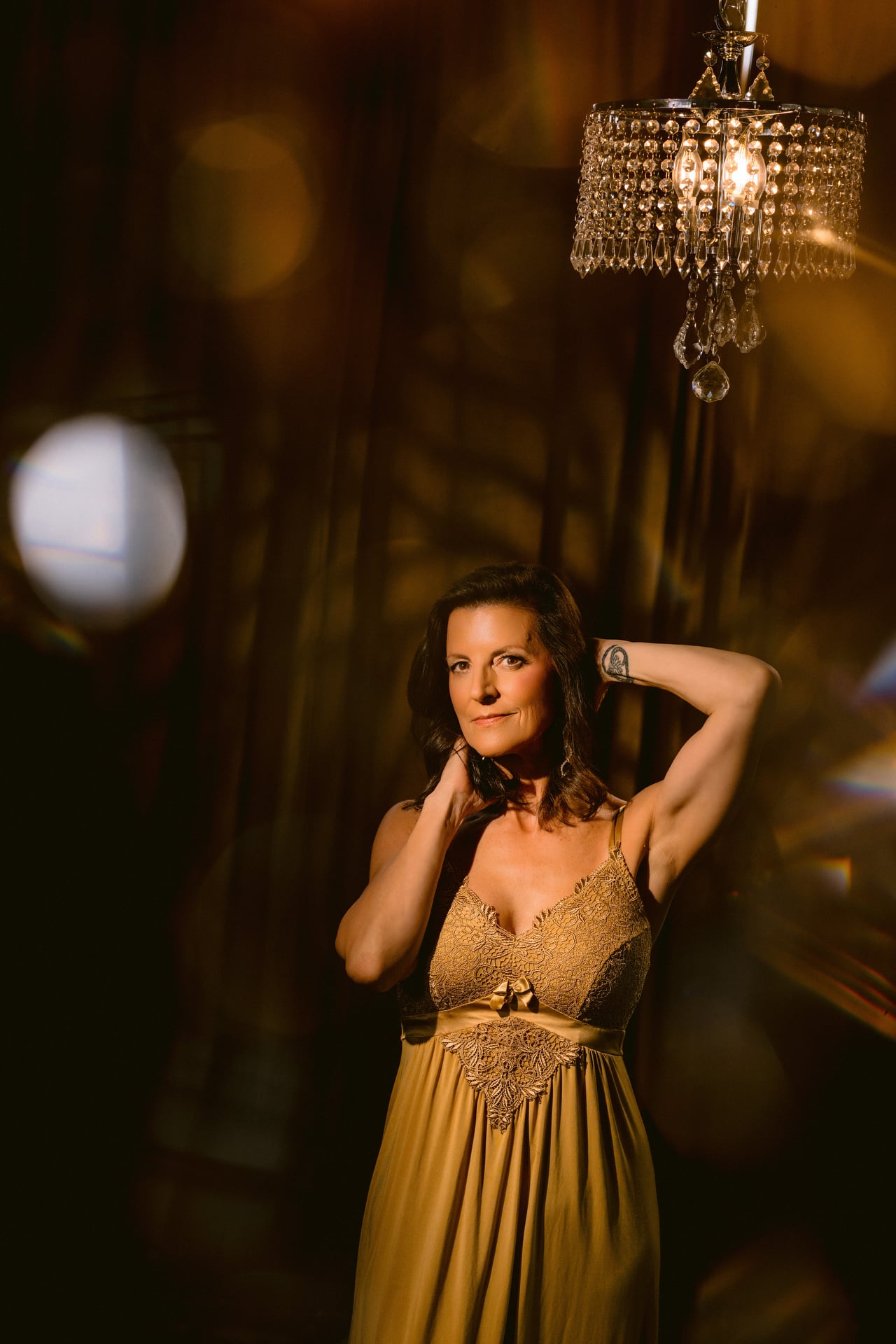 Confident woman posing in a glamorous outfit at Allebach Photography