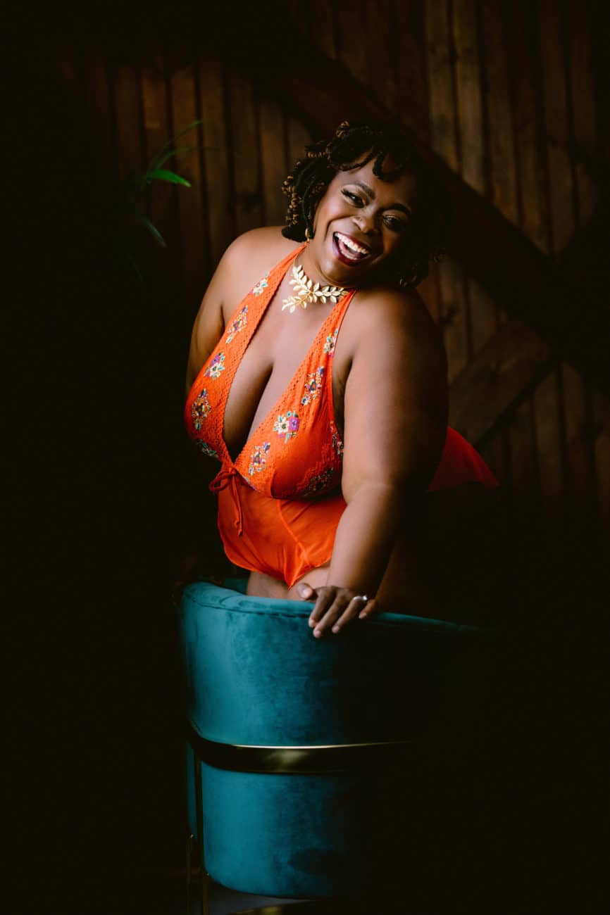 Plus-size client laughing during her boudoir photoshoot at Allebach Photography studio