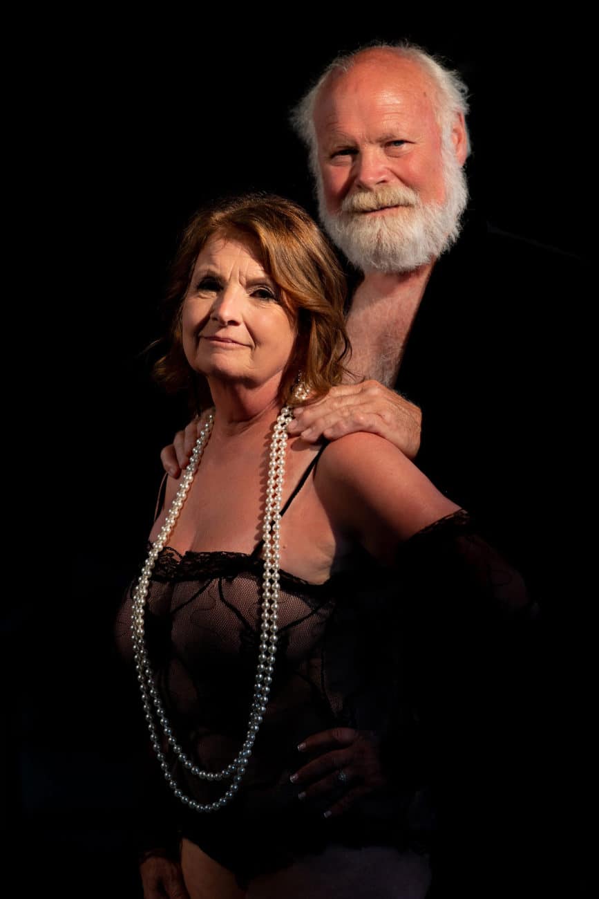 Older couple smiling during couples boudoir session in our studio