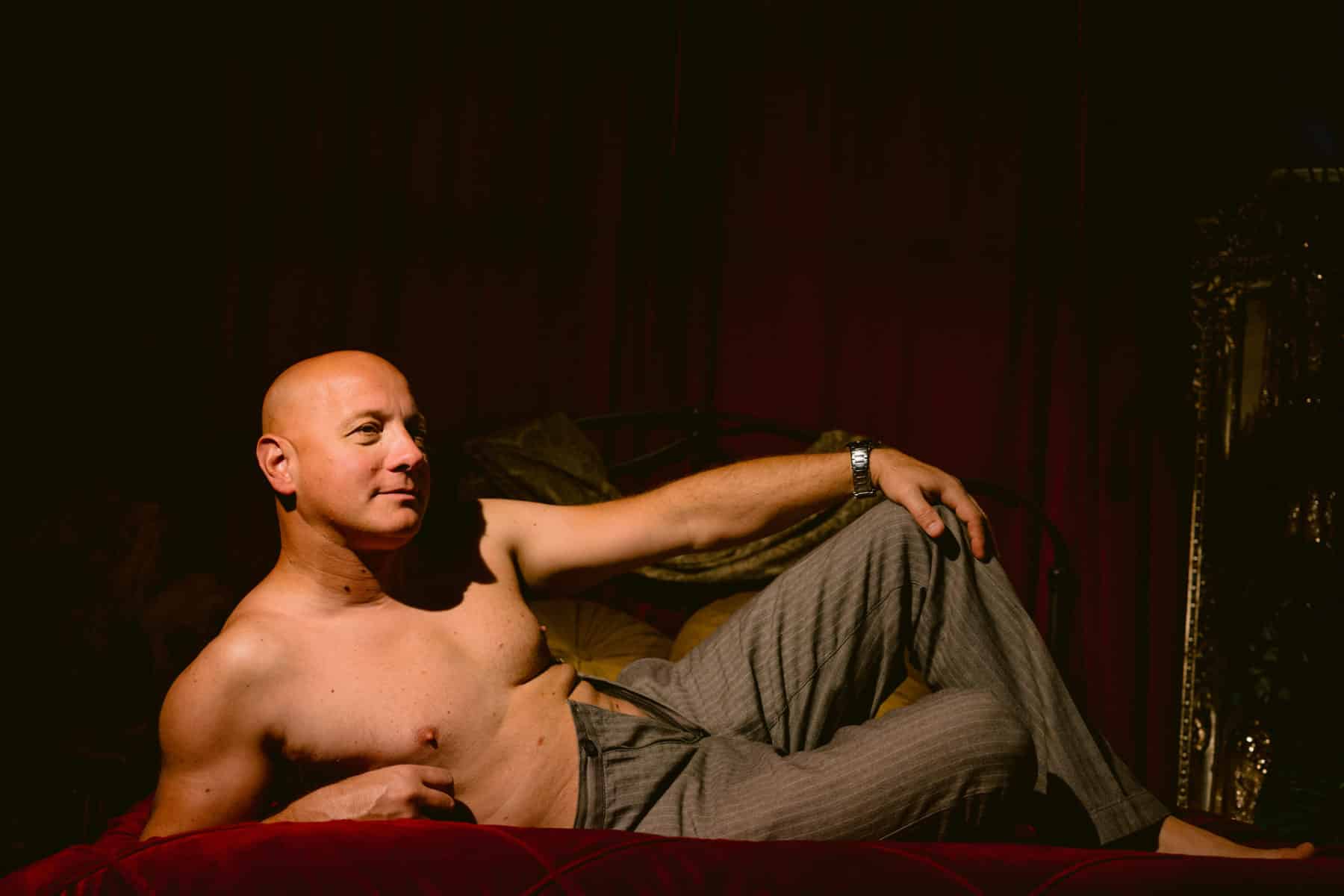 Solo image of man during couples boudoir session with wife