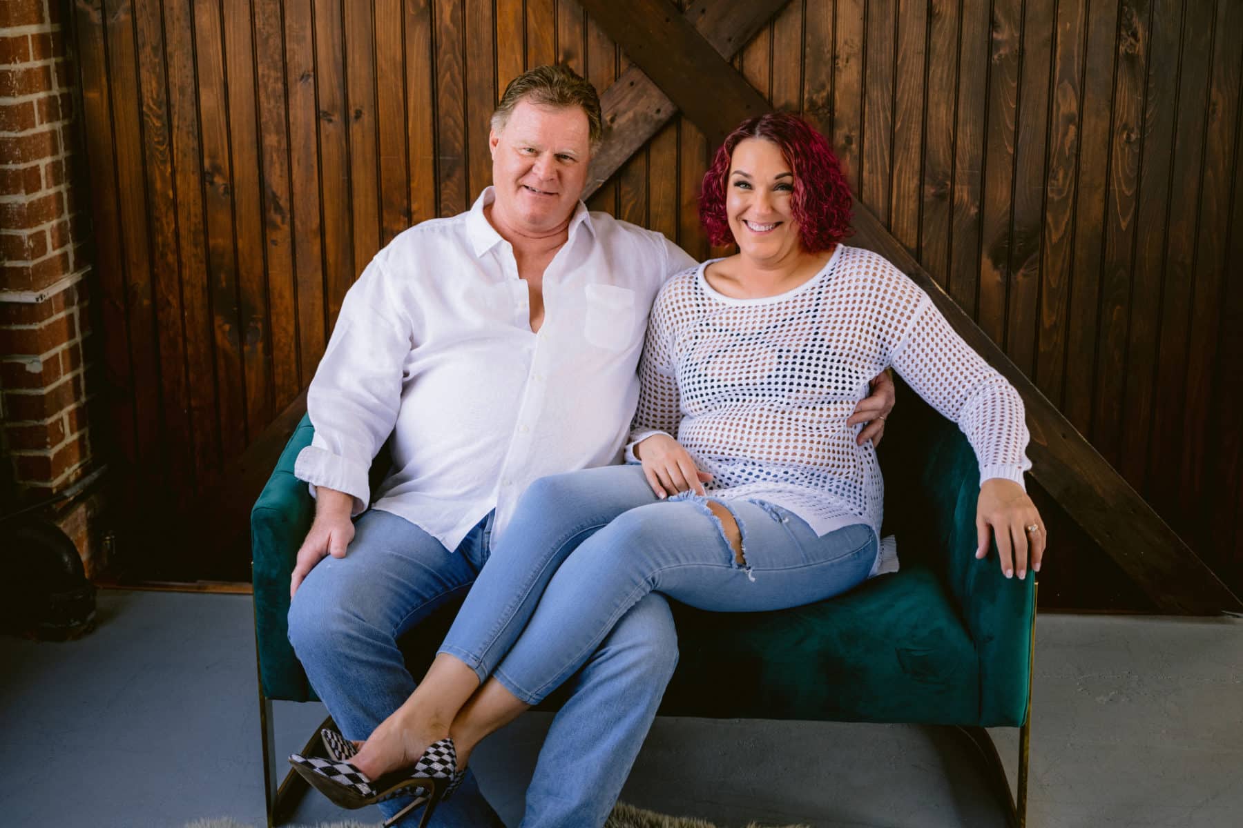 Beth and Pat laughing together in casual jeans and white shirts during their couples boudoir session at Allebach Photography.