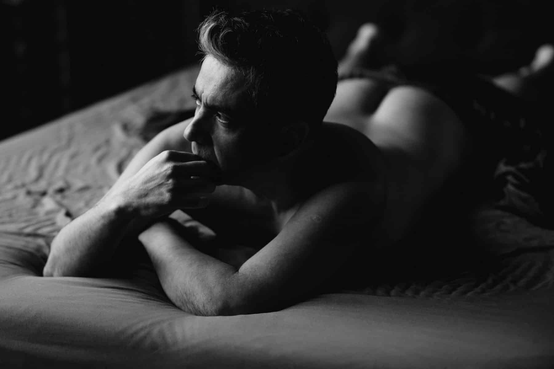 Sensual and moody men’s boudoir photography celebrating self-love and empowerment.