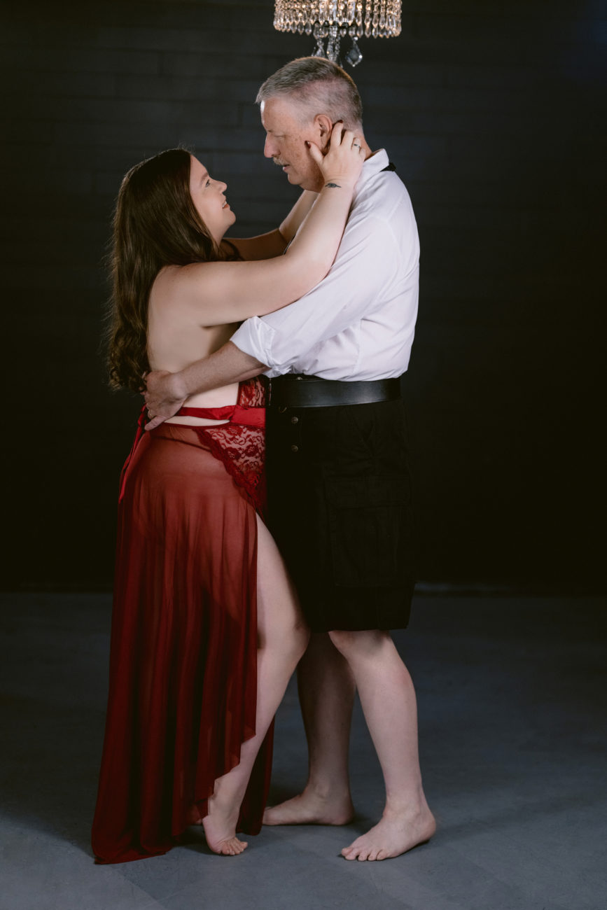 Lovers embracing each other in romantic boudoir session