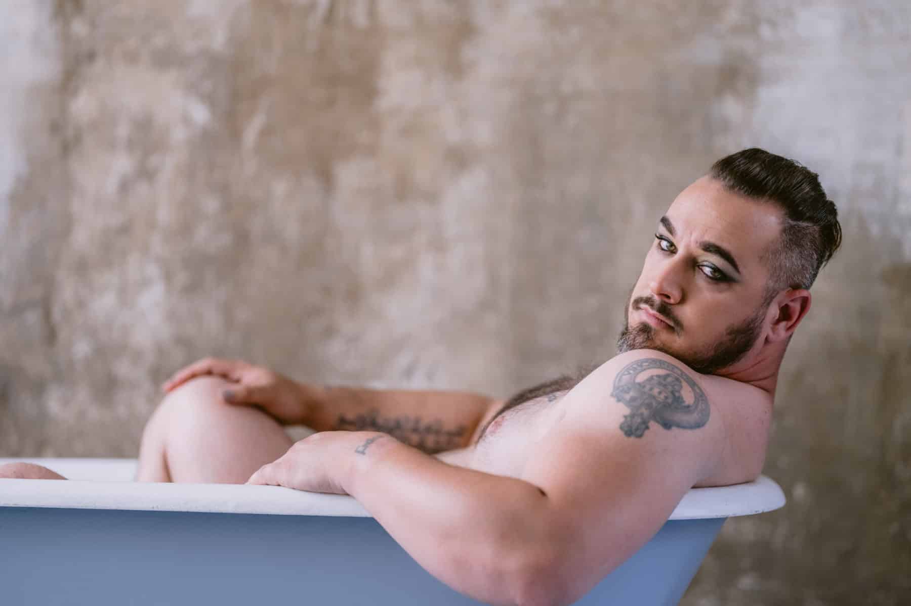 Nude male boudoir photo in tub