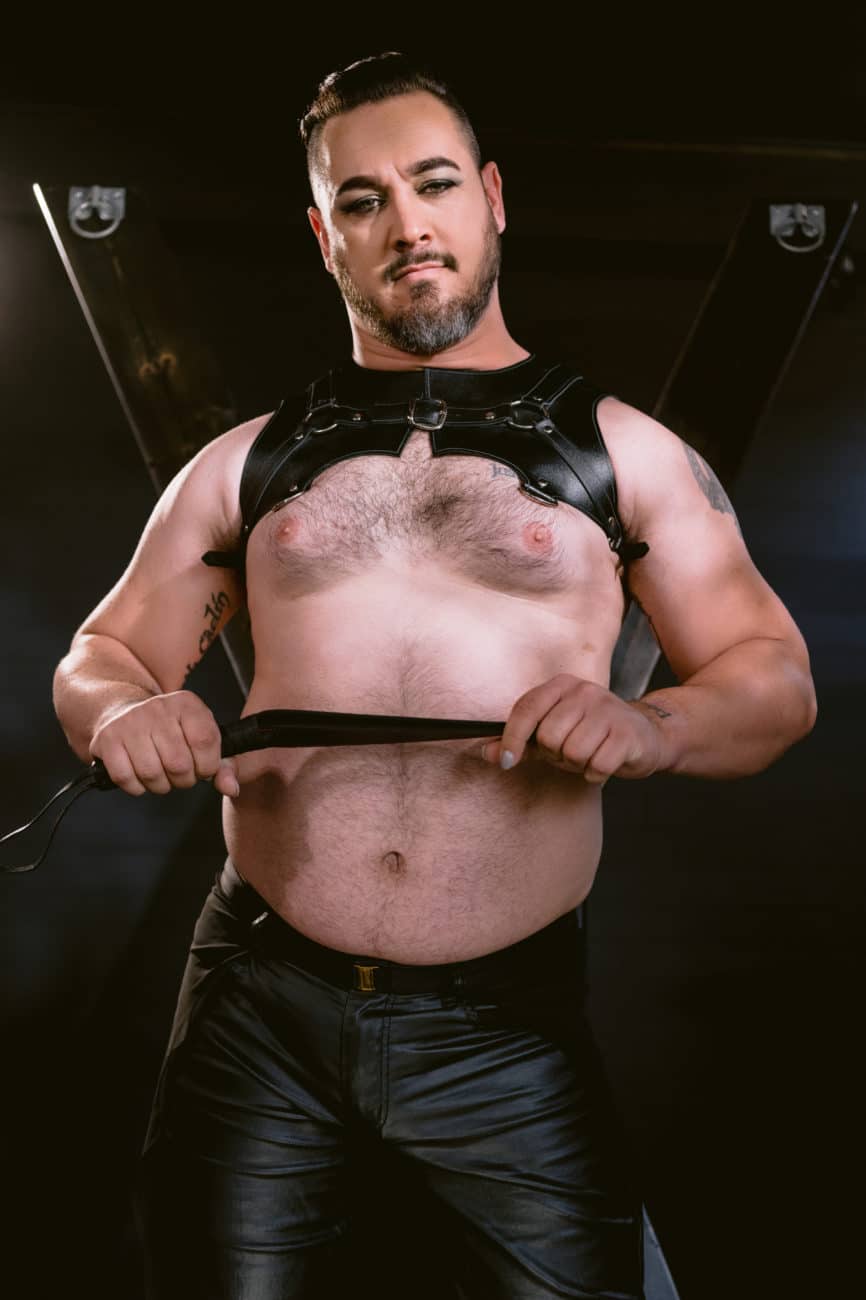 Gay men's boudoir, kink, harness and strap with saint andrews cross