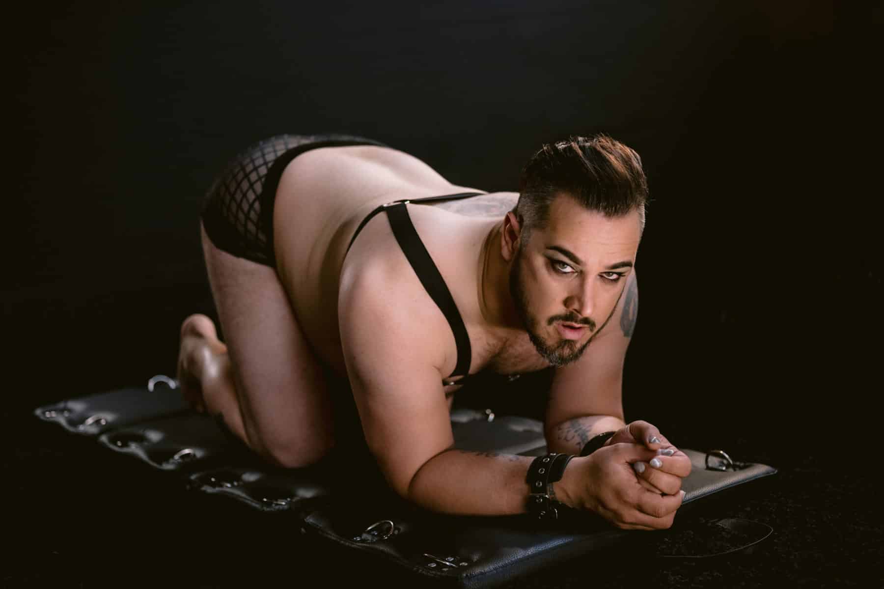 Hot male boudoir, bdsm sub position, hands and knees, strapped to board